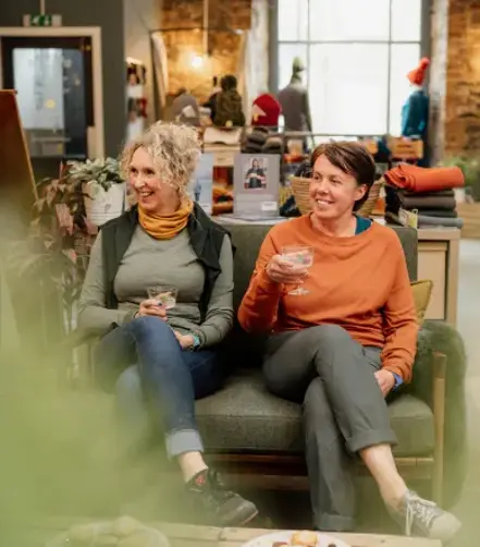  Alex from Findra and a friend sitting on the couch, enjoying a serve made with Ben Lomond Gin in their collaboration.